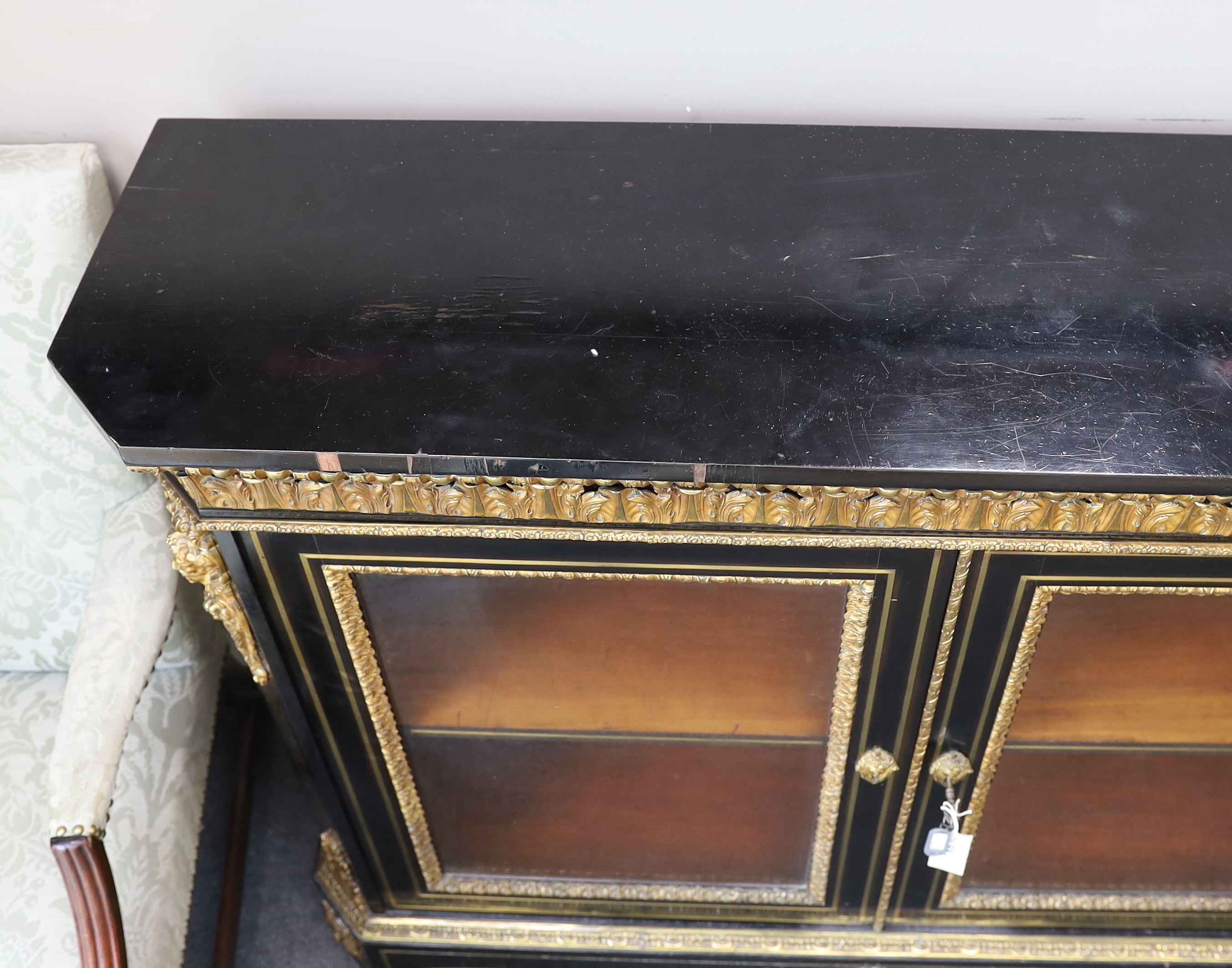 A 19th century French gilt metal mounted ebonised two door side cabinet, width 140cm, depth 38cm, height 107cm